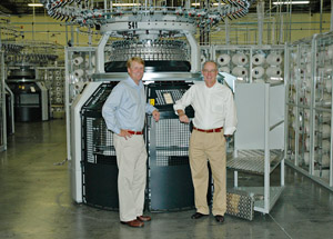 Iv Culp (on the left) and Blair Barwick in the Culp production line in the USA in front of a Mayer & Cie. circular knitting machine model OVJA 1.6 EM.