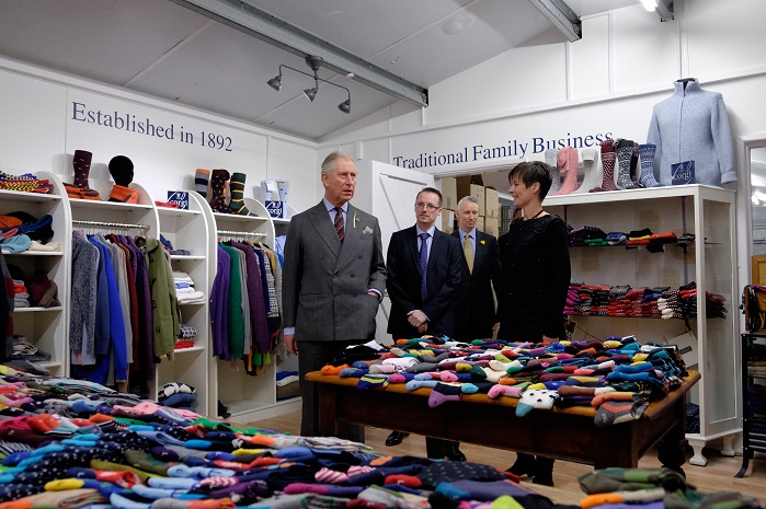 Prince Charles is shown some of the products in the factory shop by co-owner Lisa Wood. © Dimitris Legakis/REX