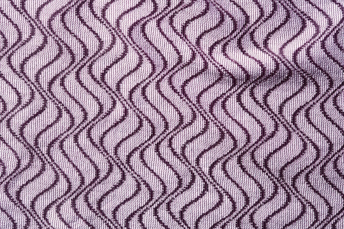 Raschel-knitted fabrics with geometric patterns and two-colour effects produced by the package dyeing of polyamide and Tencel. © Karl Mayer
