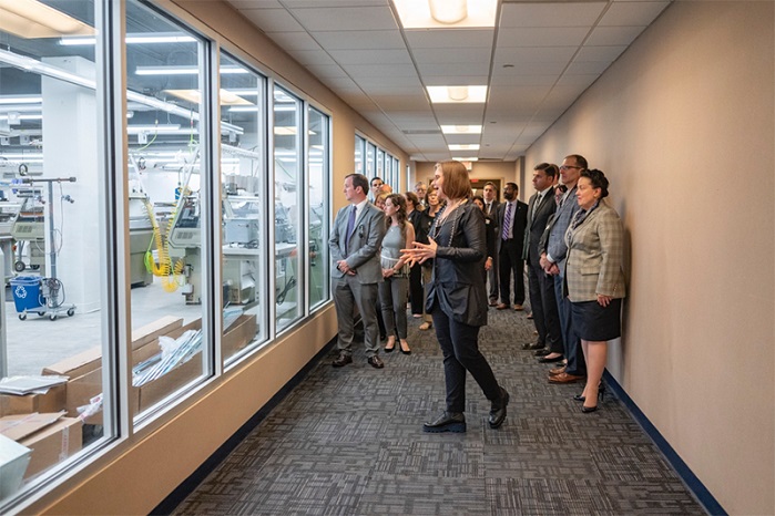 Director Geneviève Dion leads tour guests, as they view the manufacturing space for the first time before entering. © Drexel University