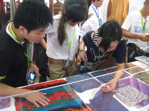 Checking out knitwear swatches at SpinExpo Shanghai