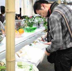 Visitors to SPINEXPO Shanghai, where visitor numbers were up by 22%, inspect fabrics