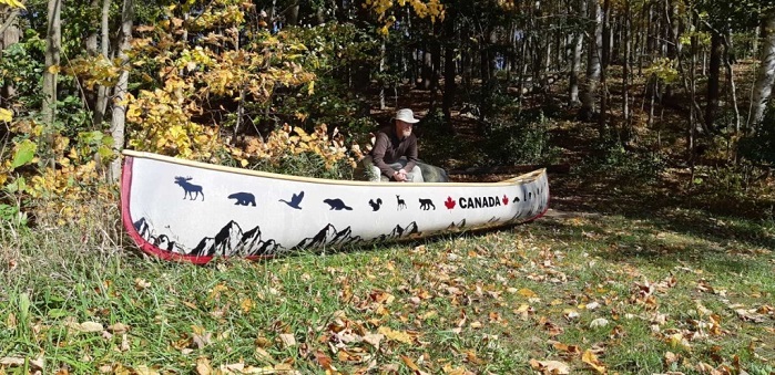 Andy sitting by Canada boat. © VISIONKnit