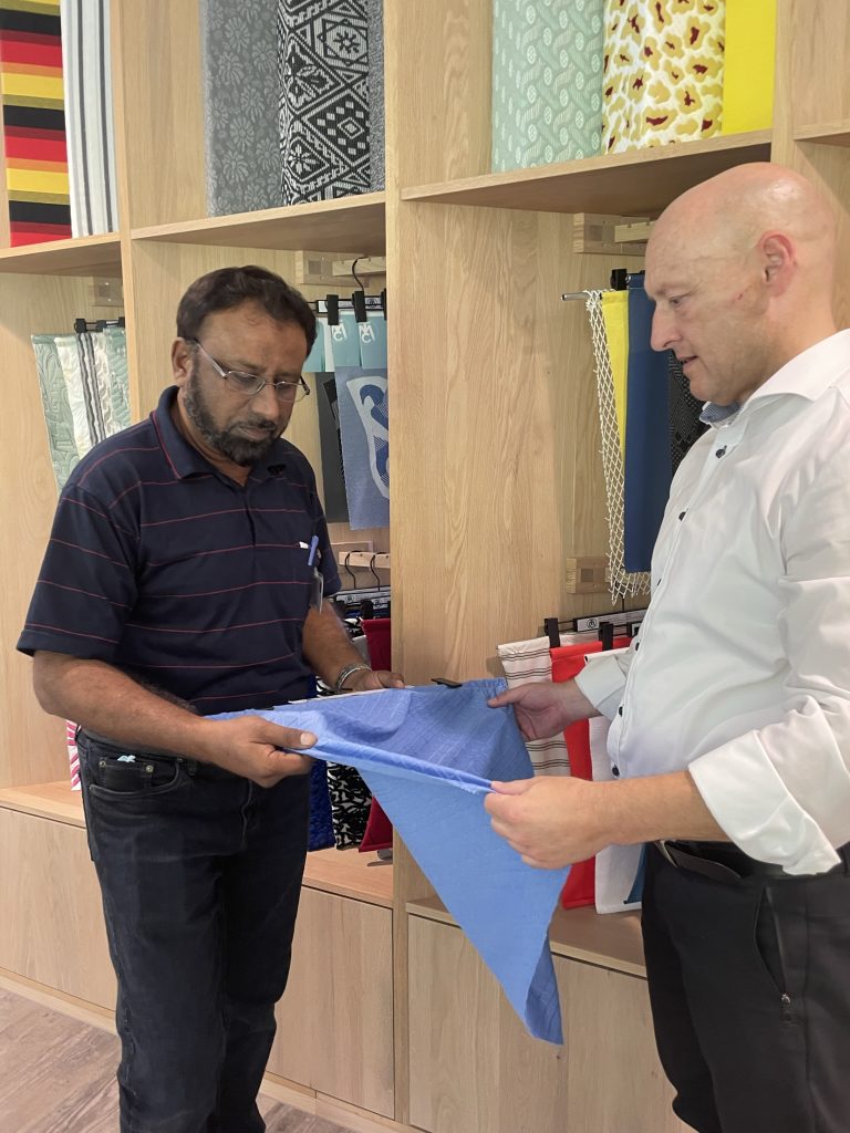 Akbar Affandi and Hardy Bühler inspecting a piece of fabric. © Mayer & Cie.