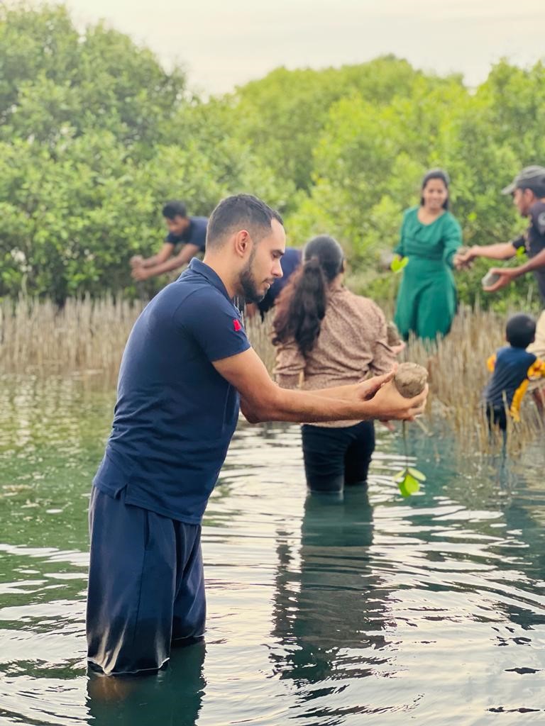 MAS employees involved in a mangrove restoration project. © JAAF