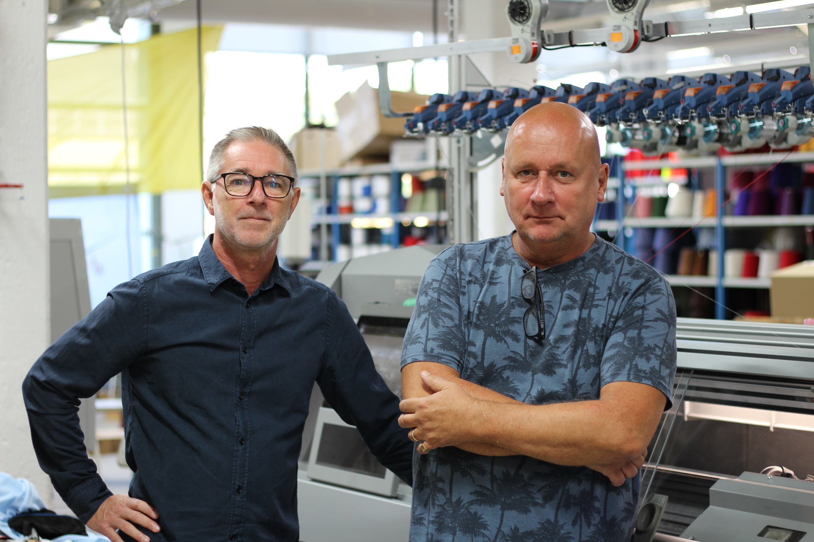 Flat knitting experts Kristian Roedby (left) and Lars Brandin with the Stoll ADF 530KI knitting machine. © Swedish School of Textiles
