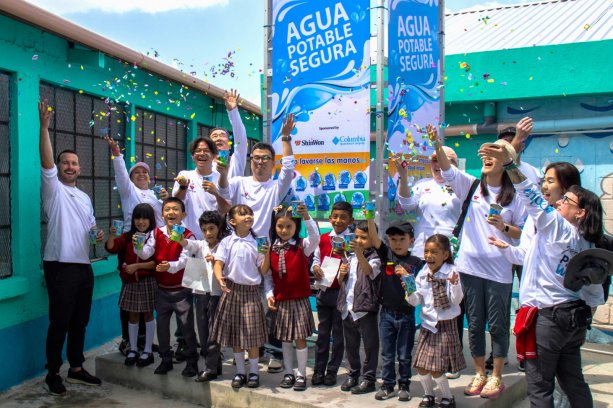 ShinWon, Columbia Sportswear, and Planet Water Foundation employees celebrate the installation of the Aqua Tower with students at El Patrocinio in Guatemala. © ShinWon Corporation