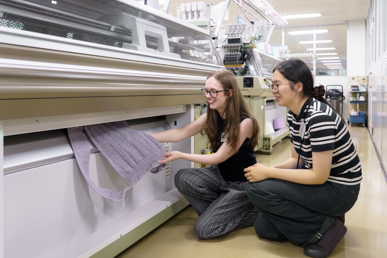 Beth and Jingwen working on a Shima Seiki WHOLEGARMENT knitting machine. © Shima Seiki